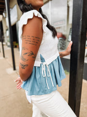 Soft knit short sleeve sweater with ruffle sleeves and peplum denim looking details with side bow detailing.