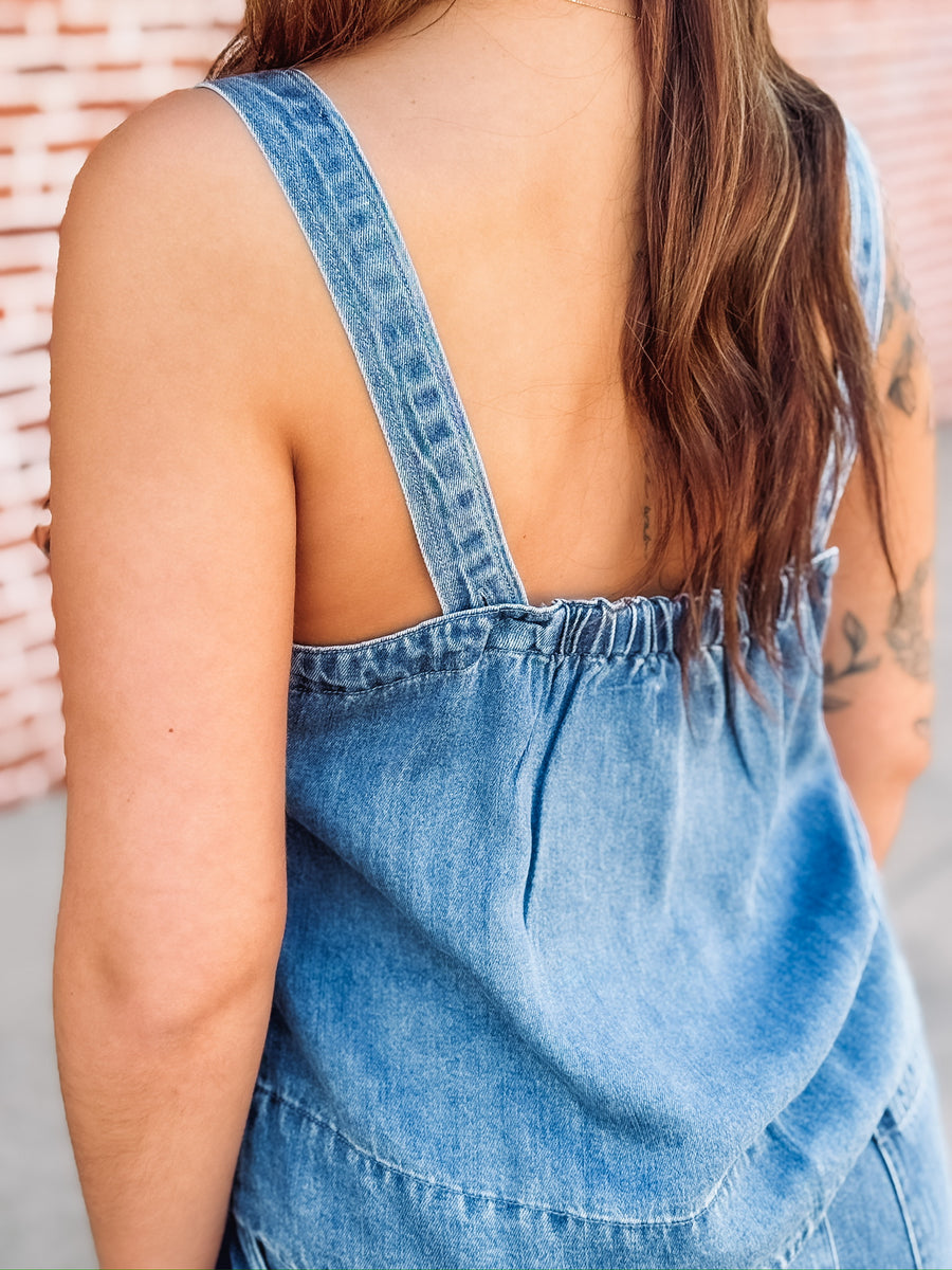 Sleeveless denim top paired with matching wide leg trouser in a relaxed two piece outfit.