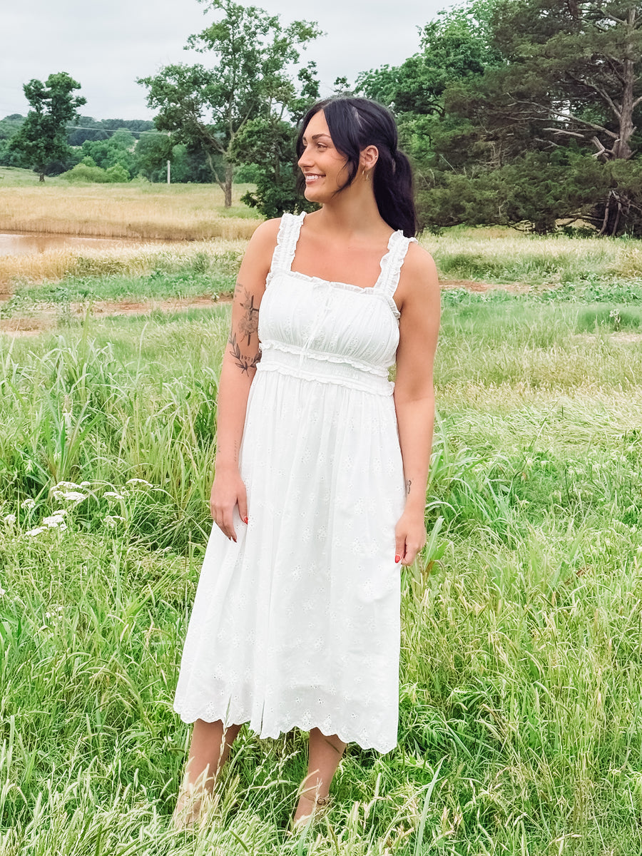 White eyelet sleeveless midi dress.
