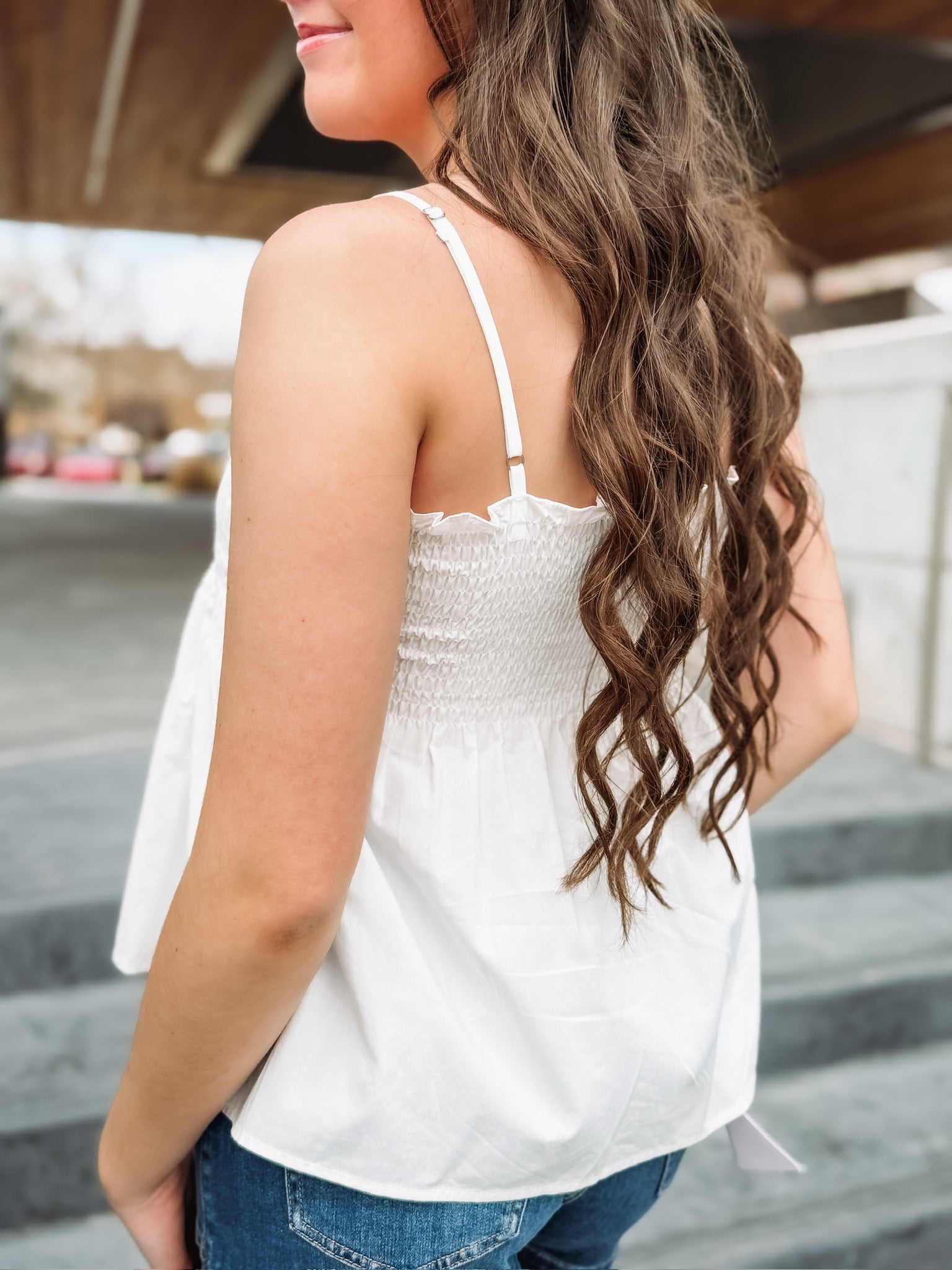 White pintuck spaghetti strap top with adjustable straps and a fit and flare look.