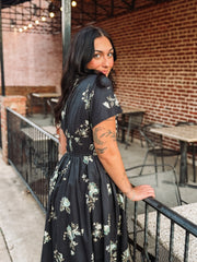 Short sleeve navy floral midi dress with v neck and zip front closure and smocked waist.