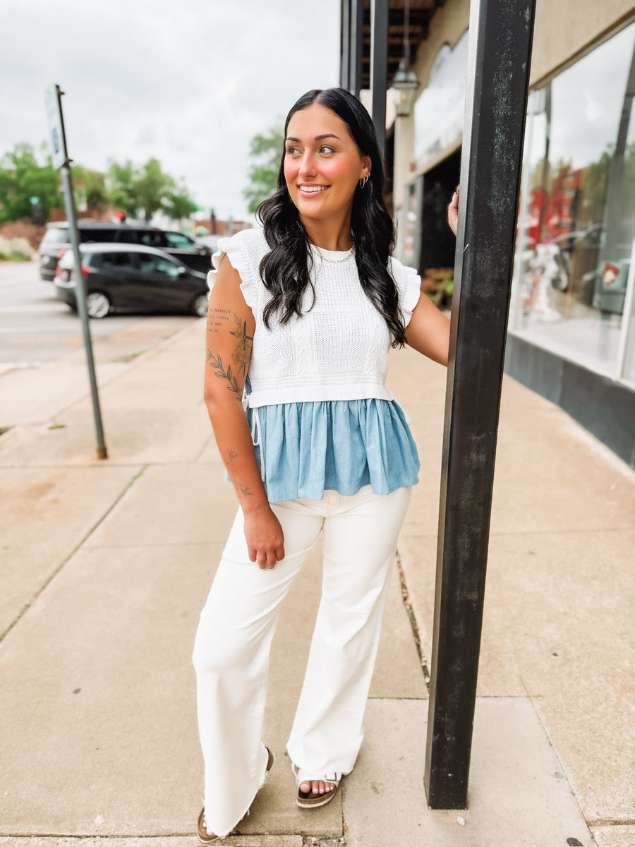 Soft knit short sleeve sweater with ruffle sleeves and peplum denim looking details with side bow detailing.