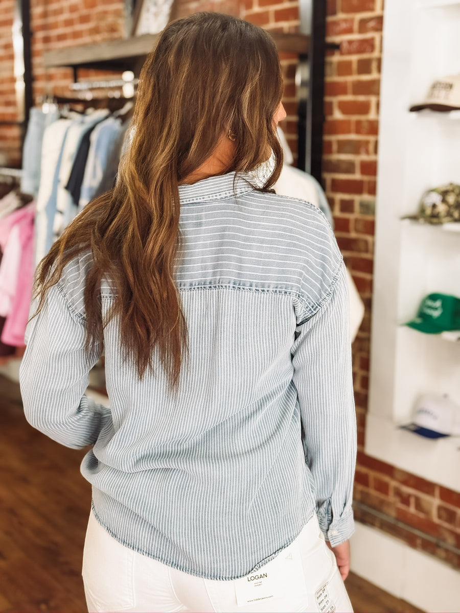 Light wash denim blouse with multi white stripes and button-up front