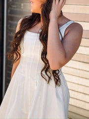 White sleeveless denim dress with a fit and flare fit and seaming detail down the bodice.