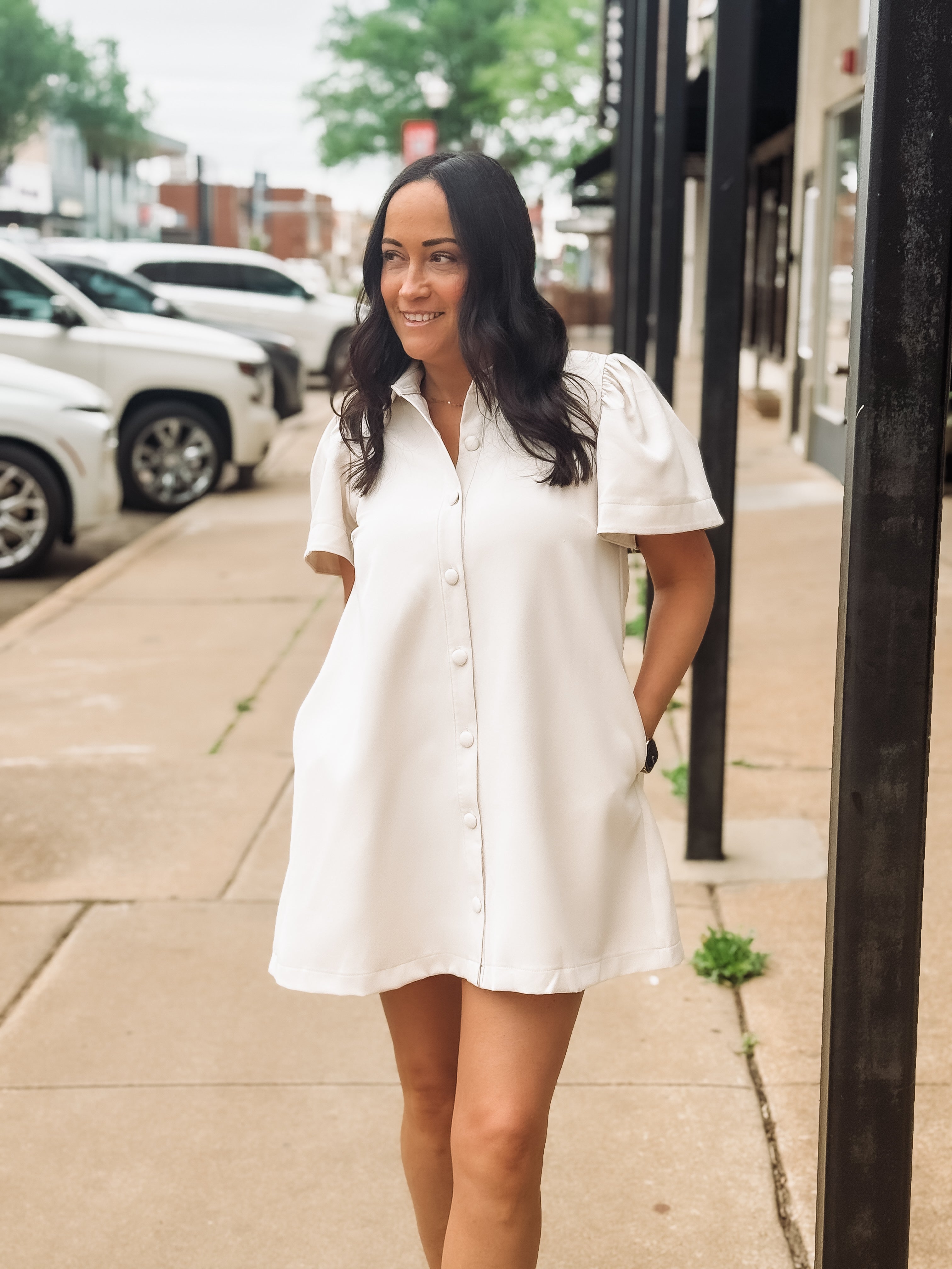 woman on sidewalk in cream tonal dress