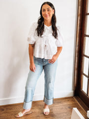 White peplum top with cut out eyelet details and bow tie front
