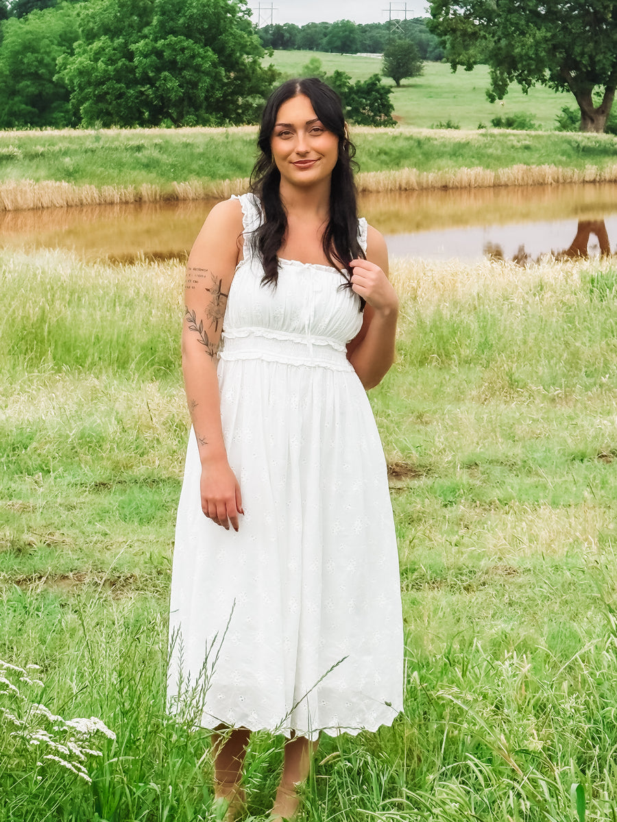 White eyelet sleeveless midi dress.