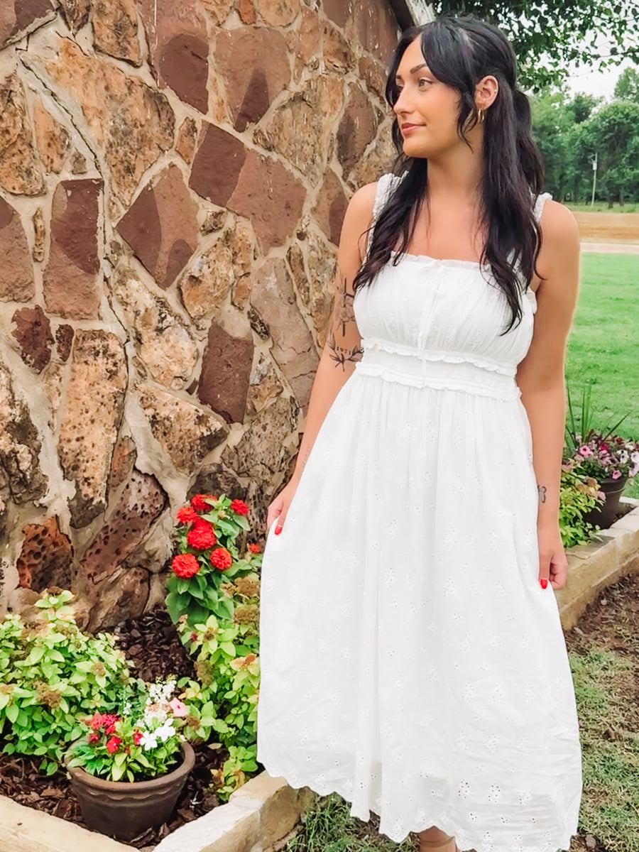 White eyelet sleeveless midi dress.