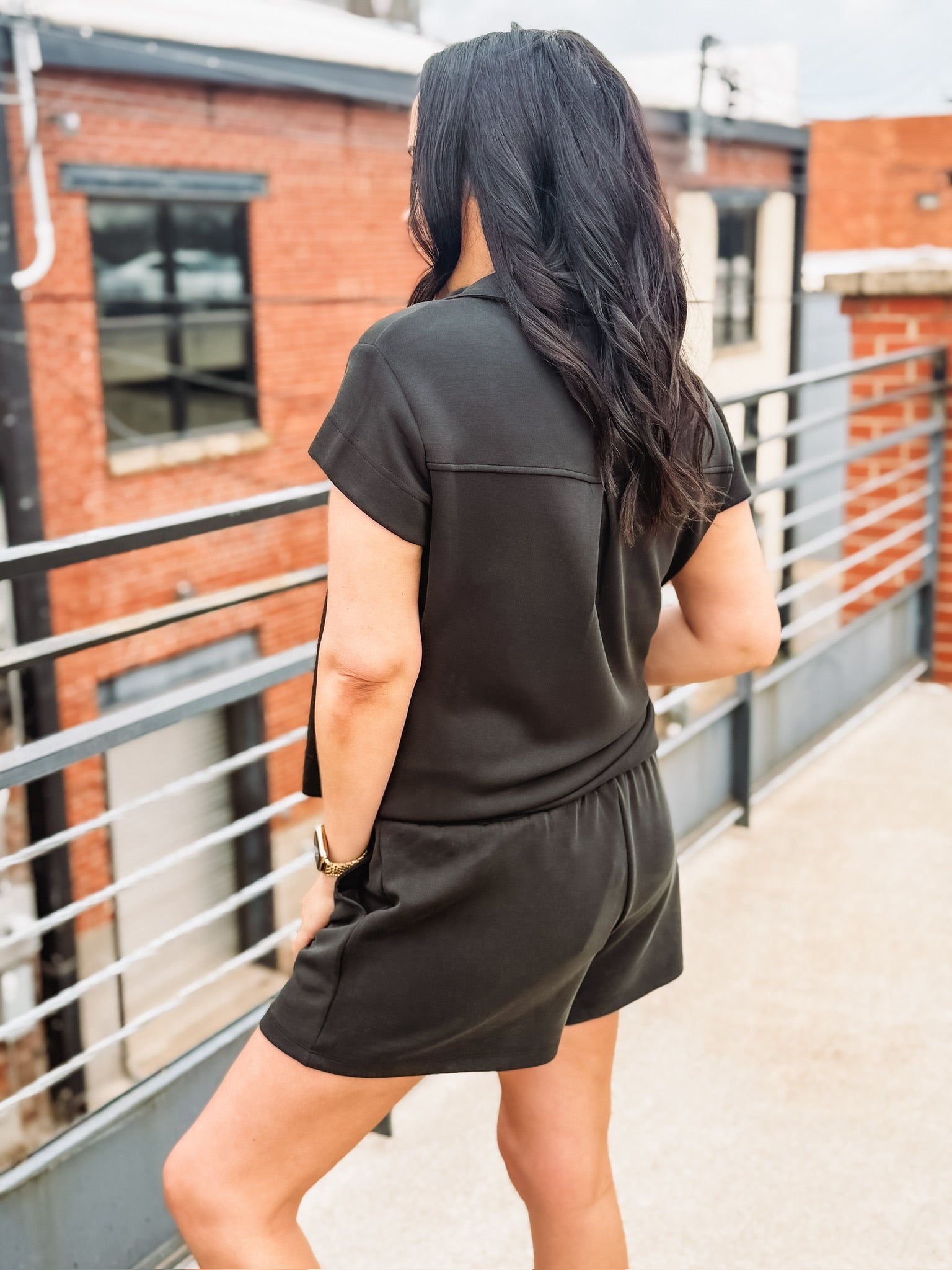 Black short sleeve scuba short set with gold sipper and end cap details from Mary Square.