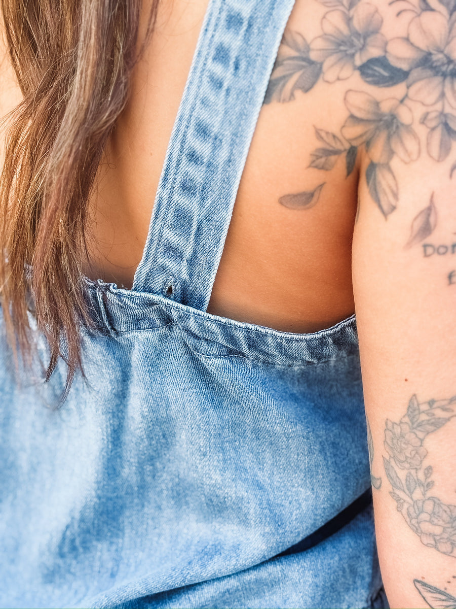 Sleeveless denim top paired with matching wide leg trouser in a relaxed two piece outfit.
