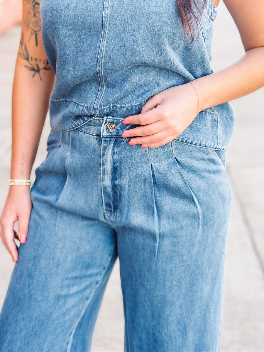 Sleeveless denim top paired with matching wide leg trouser in a relaxed two piece outfit.