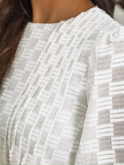 White long sleeve blouse with tonal checkered texture and shiver balloon sleeves.