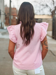 Pink ruffle sleeve pinstriped blouse with a ruffle neckline and a self tie detail.