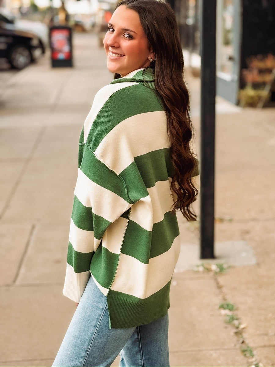 Green and cream striped quarter-zip pullover.