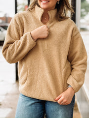 Tan sherpa quarter-zip pullover with front pockets.